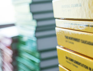 One yellow collection of books, one green collection and one red collection, all oiled up next to each other